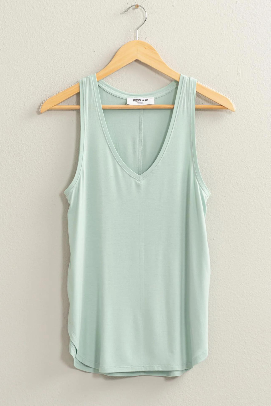 front view of joey v neck tank in the color seafoam hanging on a hanger 