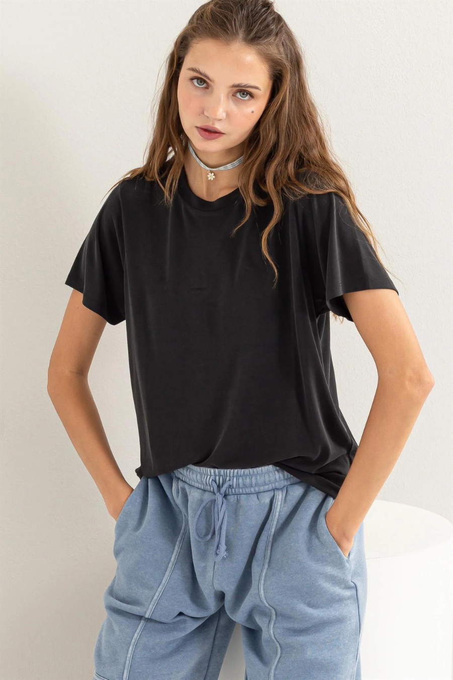 girl standing with close up front view of the mickey staple t in black 