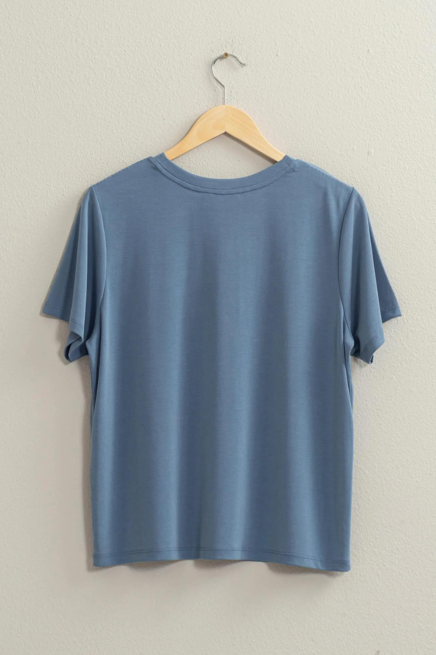 full back side view of the mickey staple t in the color ocean, hanging on a hanger 