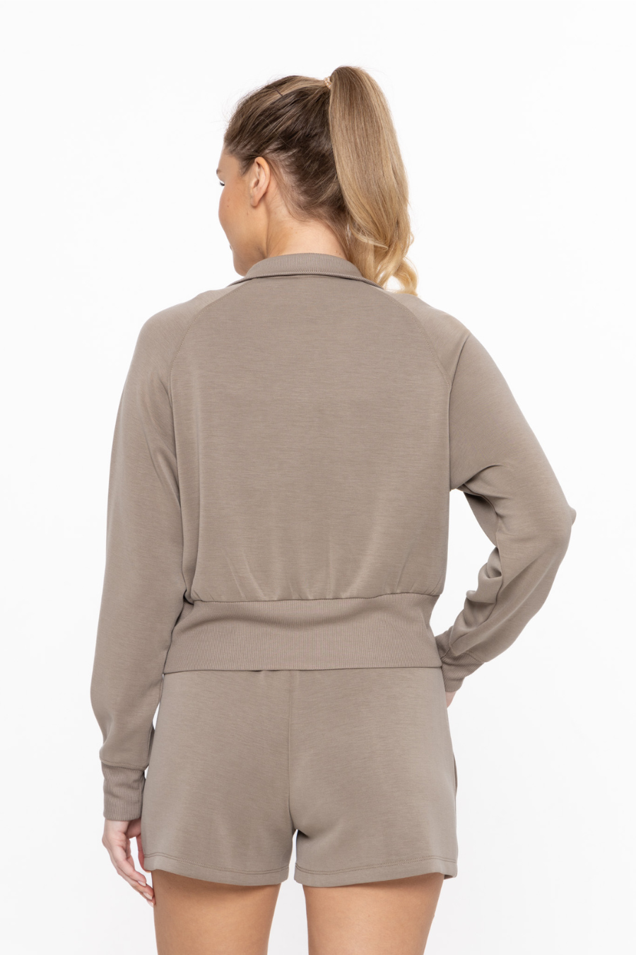 Close up back view of the cropped mock neck zip up jacket in the color khaki