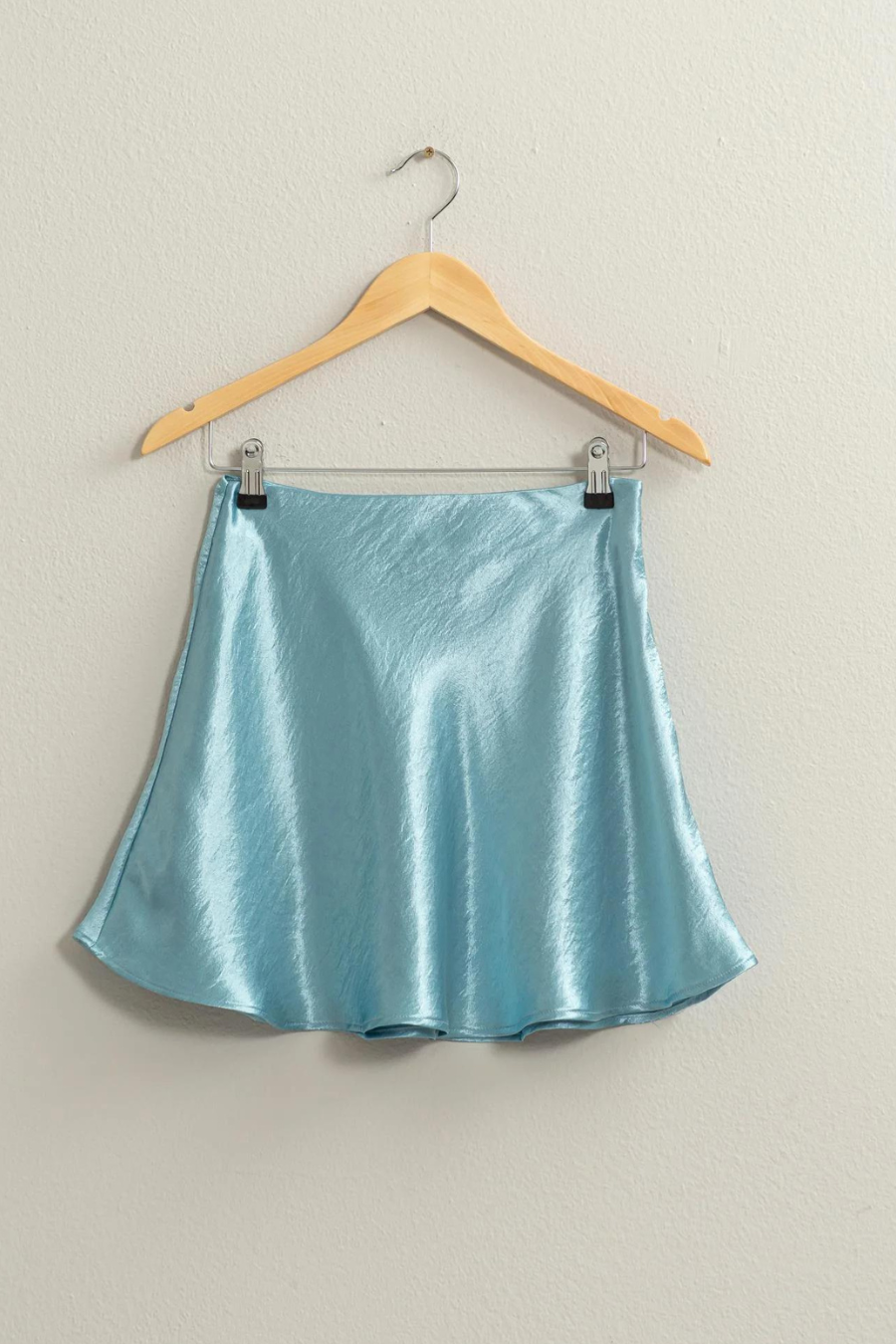 full length front view of the Teddi satin mini skirt in the shade, aqua, skirt is having on a wooden hanger