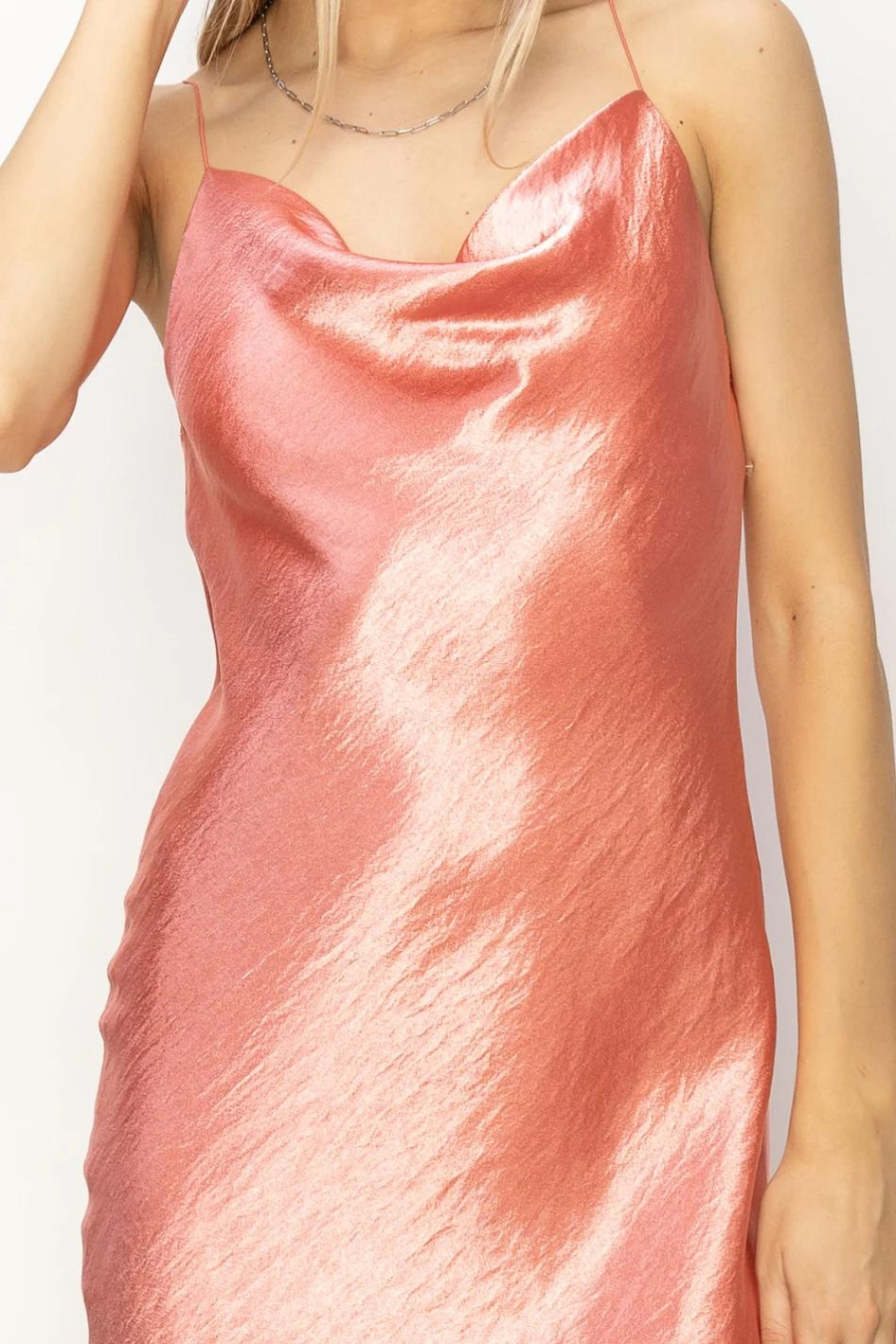 close up front view of the cowl neck on the stassi dress in the color coral