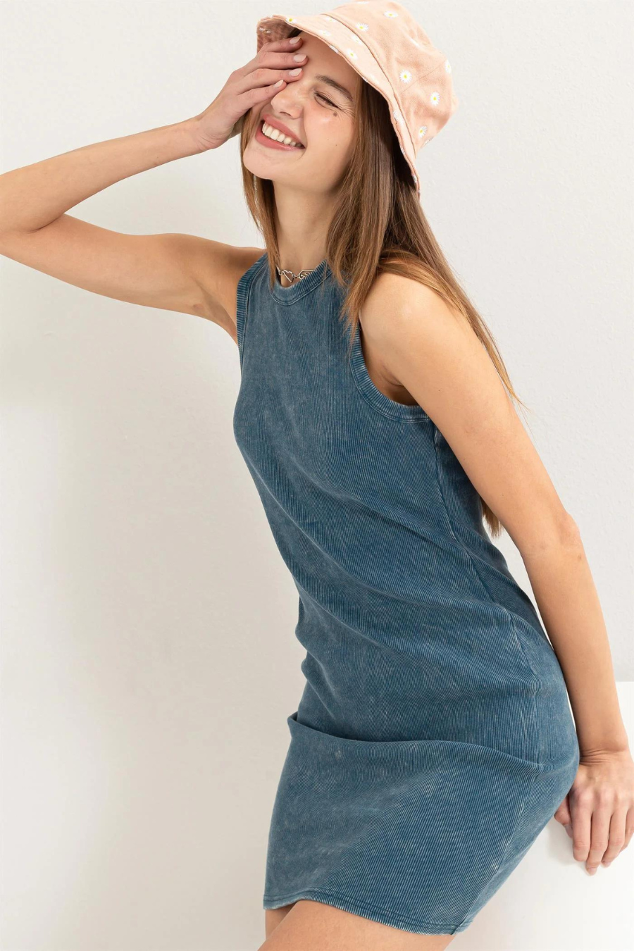 close up side view of the lex acid washed ribbed dress, model is wearing it with a pink bucket hat 