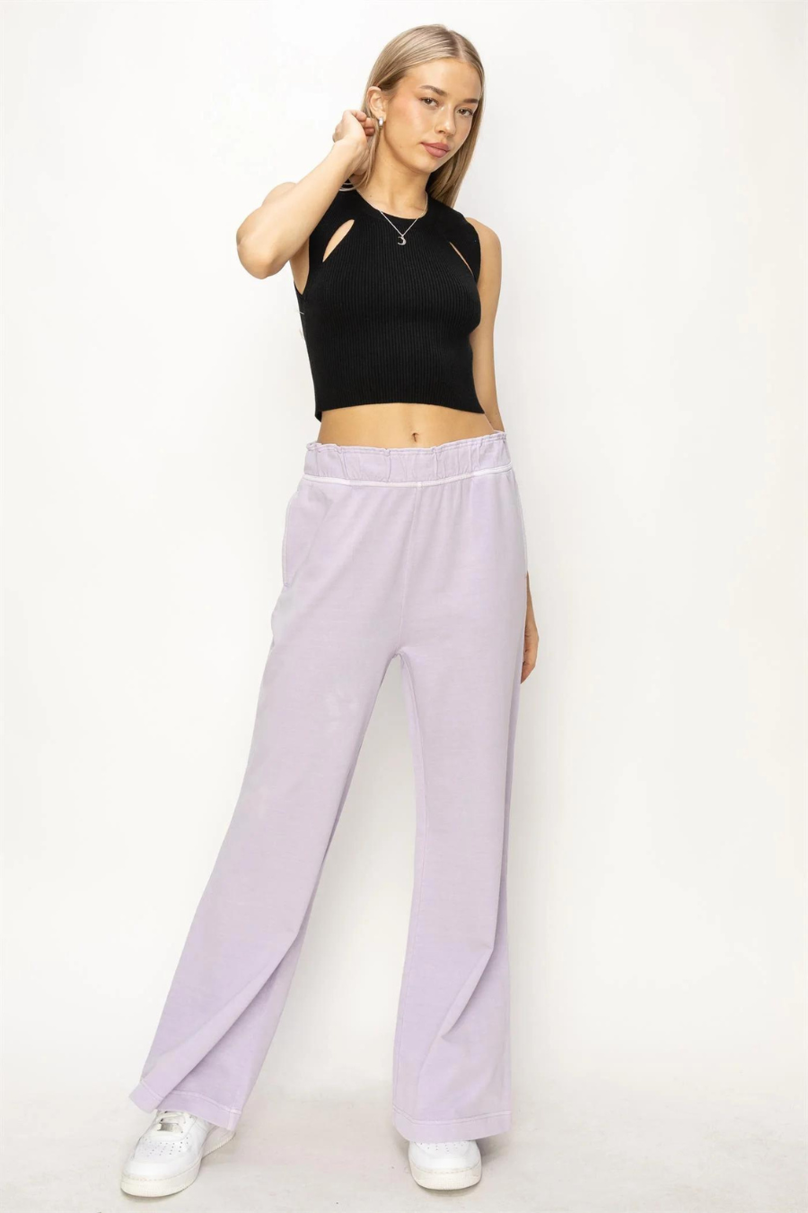 full length front  view of Presley high waist flare pants in the color  lilac. Model is wearing is a black tank and white tennis shoes 