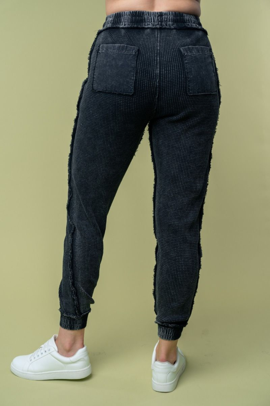 back view of hanny high waisted thermal knit joggers in black, showing off back pockets