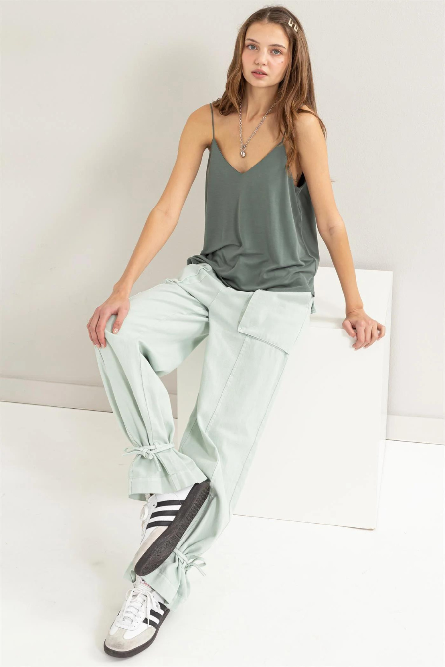 full front view of Romee v neck cami in the color forest, model is sitting