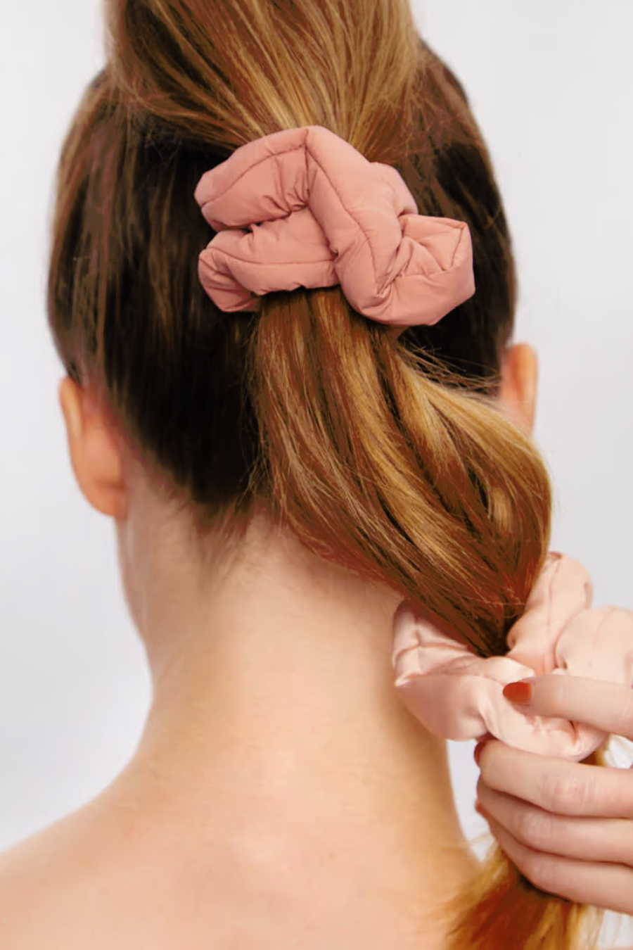 girl with a ponytail with blush satin Scrunchie in her hair 