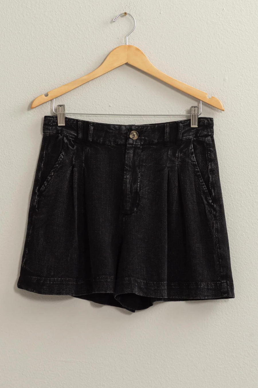 full view of black linen shorts of hanger