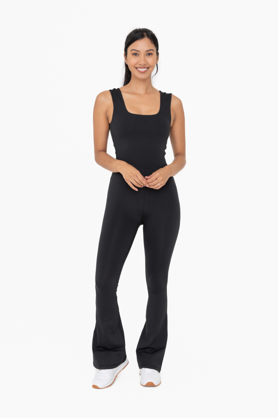 front full length view of the Venice twist back flare jumpsuit in the color black