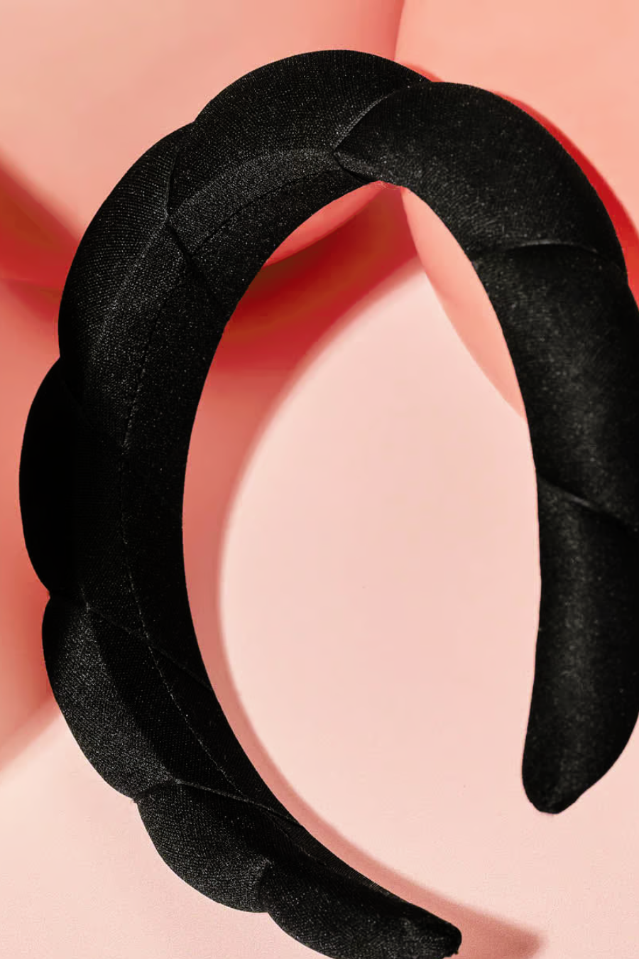 black headband on pink background