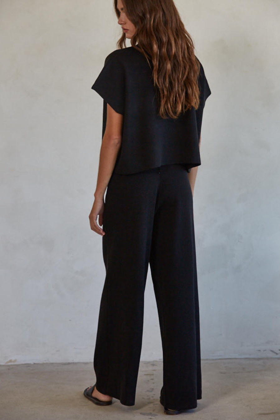 showing the back of the black knit wide leg pants 
