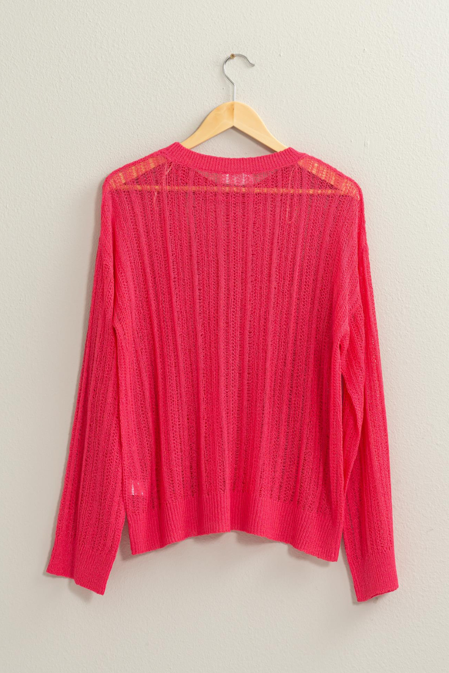 back view of pink lottie sweater of wooden hanger 