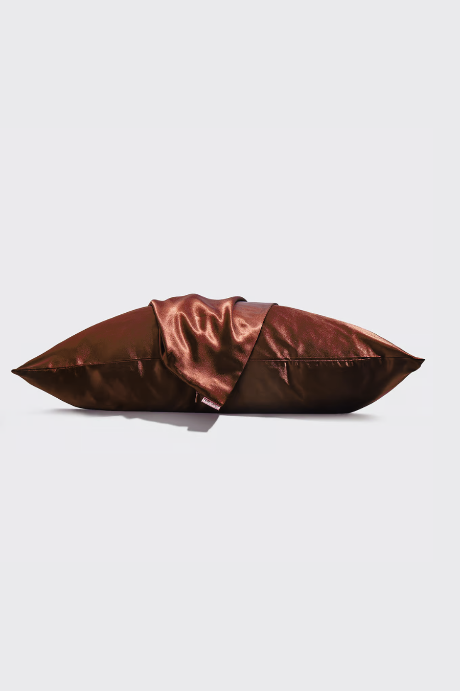 cocoa satin pillow case laying flat with a 2nd satin pillow case wrapped over it