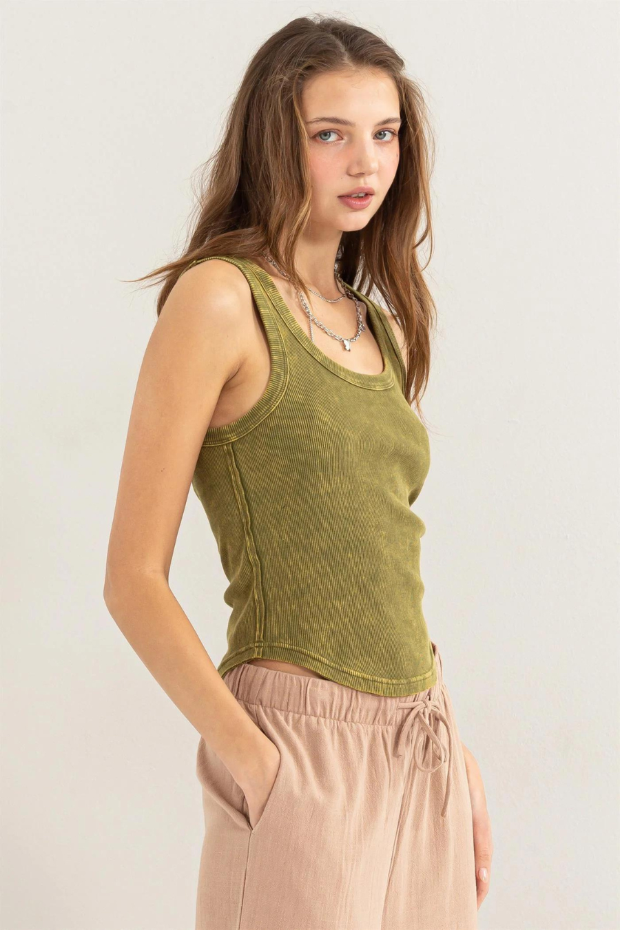 close up side view of girl wearing dixie acid wash tank in olive