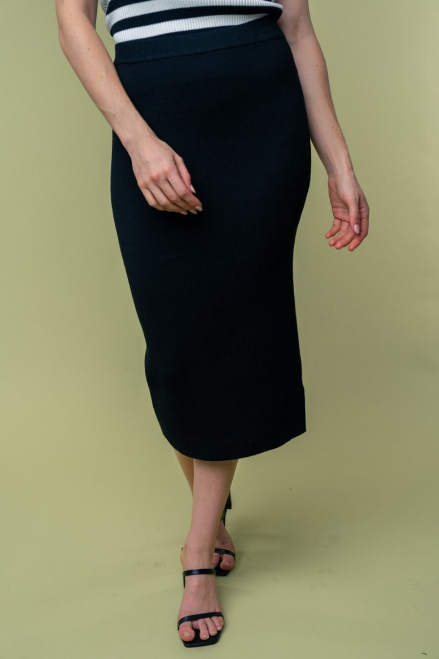 close up front view of Juliana high waisted knit midi skirt in the color black . model is wearing it with heels