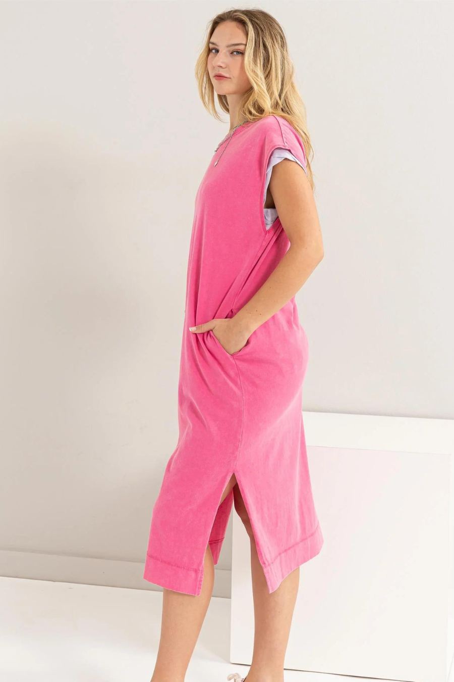 side view of the Mattie sleeveless dress, showing off pockets in the color pink