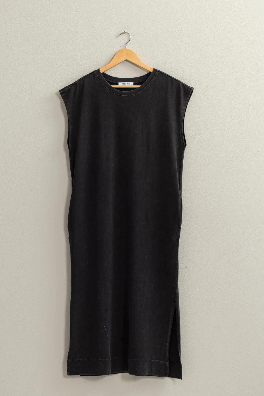 front view of the Mattie sleeveless dress hanging on a hanger in the color black 
