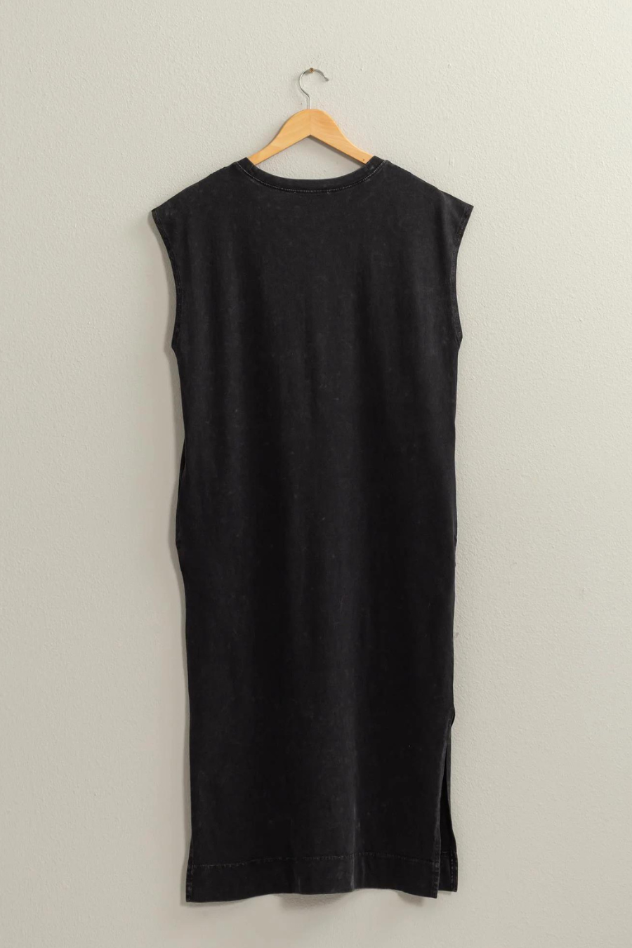 back view of the Mattie sleeveless dress hanging on a hanger in the color black 