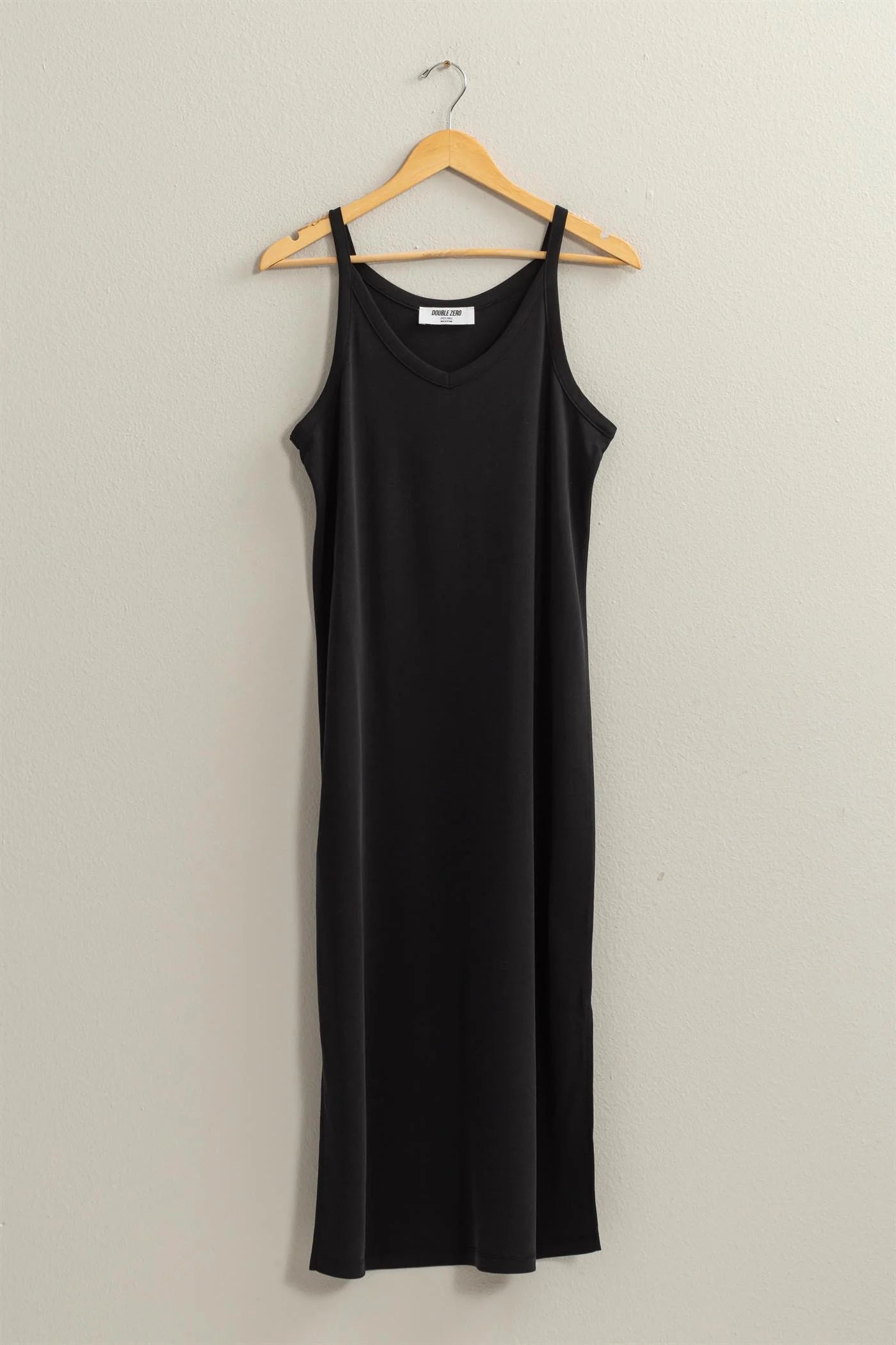 full length front view of birdie neck midi dress  in the color black hanging on a hanger 