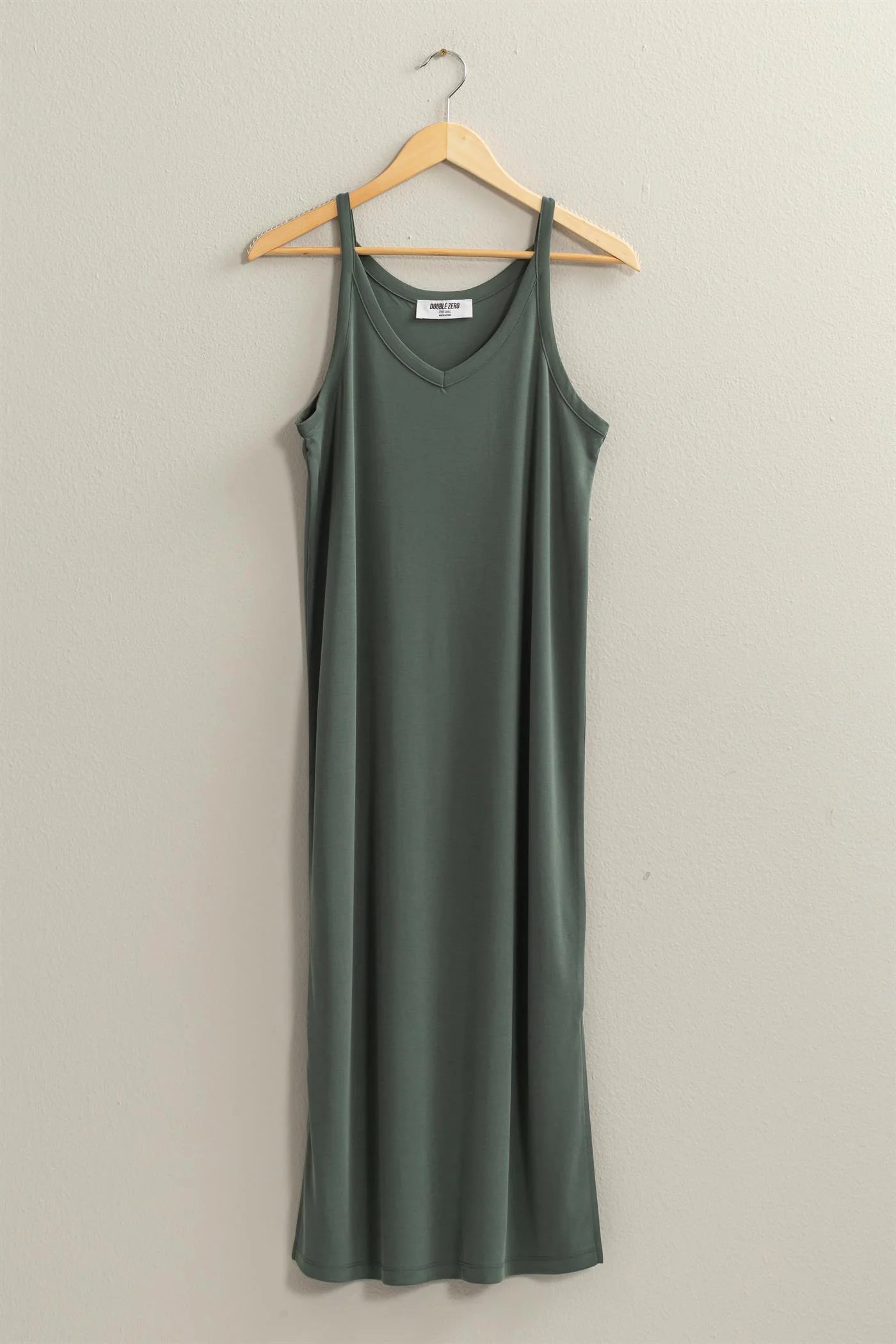 front full length view of birdie v neck midi dress in the color forest, hanging on a hanger 