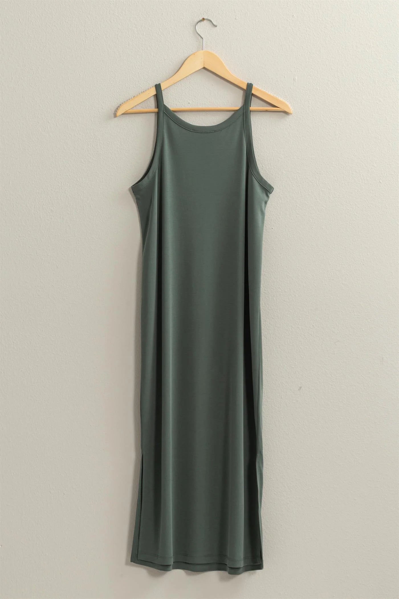 full length back view of birdie v neck midi dress in the color forest, hanging on a wooden hanger 