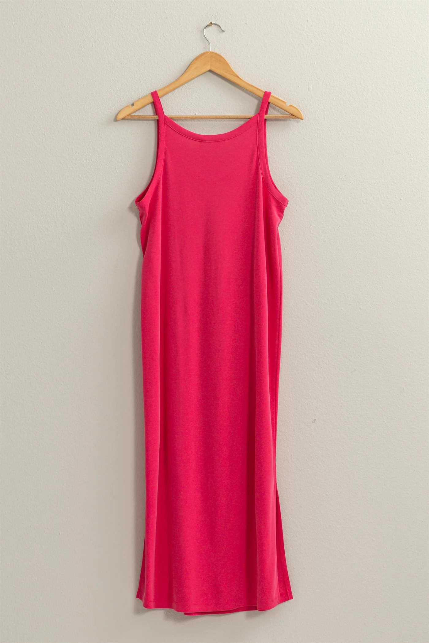 full length back view of the birdie v neck midi dress in the color pink, hanging of a wooden hanger 