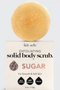 sugar scrub bar sitting on top of its packaging 