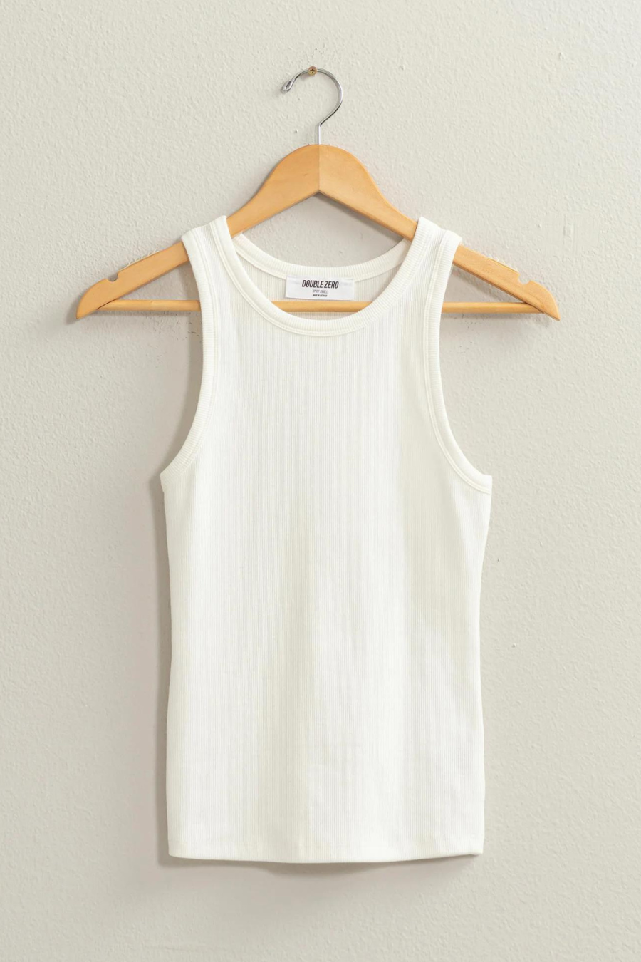 white tank top on wooden hanger 