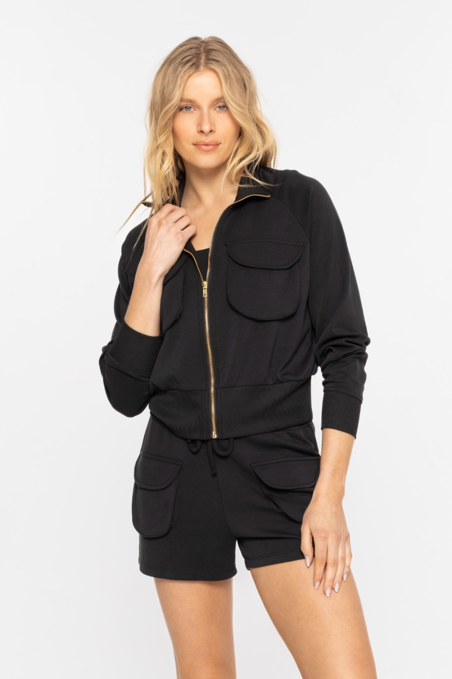 Close up front view of the cropped mock neck zip up jacket in the color black 