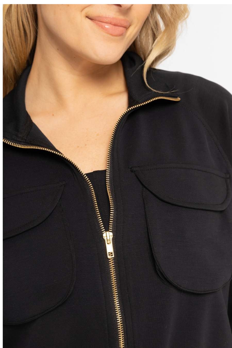 close up detail of zipper for the cropped mock neck zip jacket in the color black 