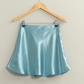 full length front view of the Teddi satin mini skirt in the shade, aqua, skirt is having on a wooden hanger 