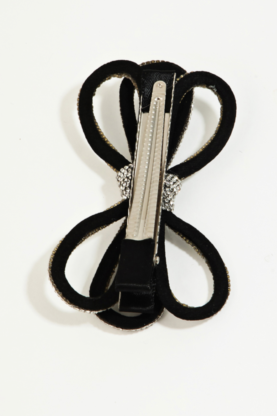 close up flat lay of back of bow clip showing the alligator clip that 