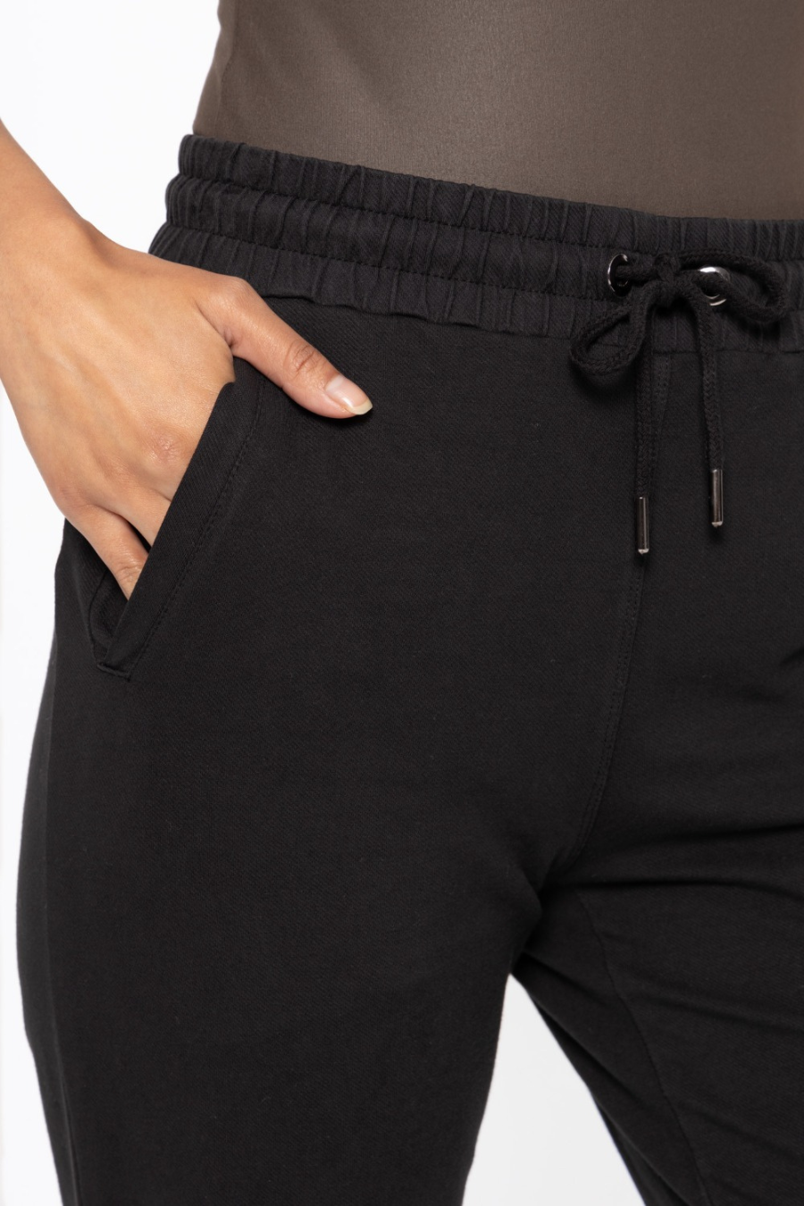 close up detail view of the swoop back twill joggers in the color black 