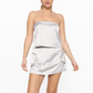 front view of smooth stride loose tube top in silver. model is wearing it with matching skort 
