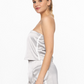 side view of smooth stride loose tube top in silver. model is wearing it with matching skort 