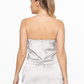 back view of smooth stride loose tube top in silver. model is wearing it with matching skort 