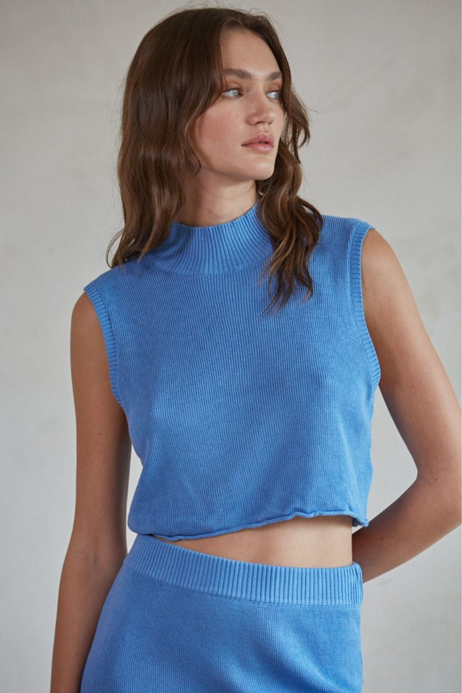 close up front view of the celeste knit sweater mock neck crop top in the color blue 