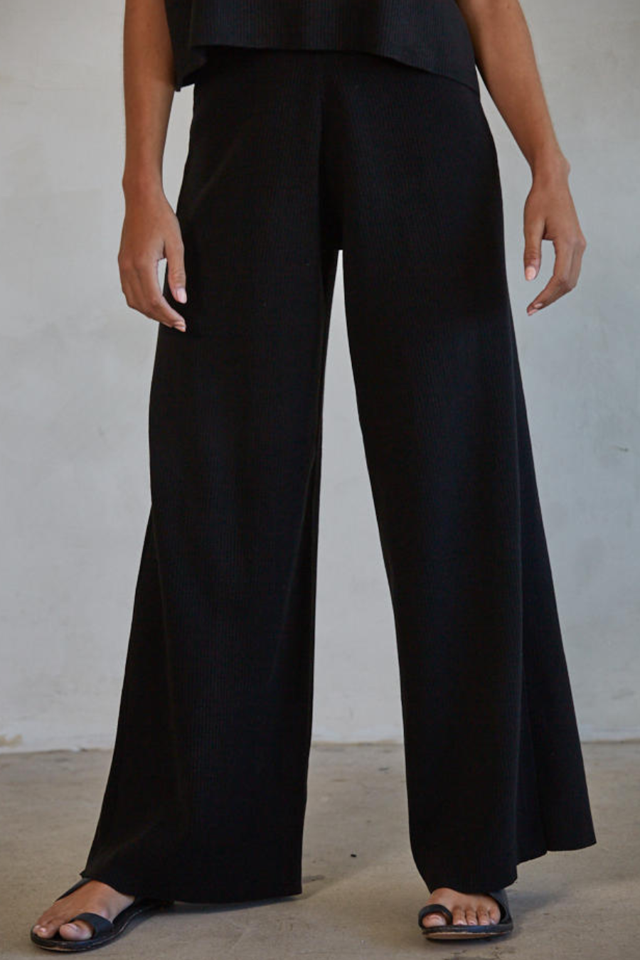 girl wearing black wide leg knit pant with sandals 