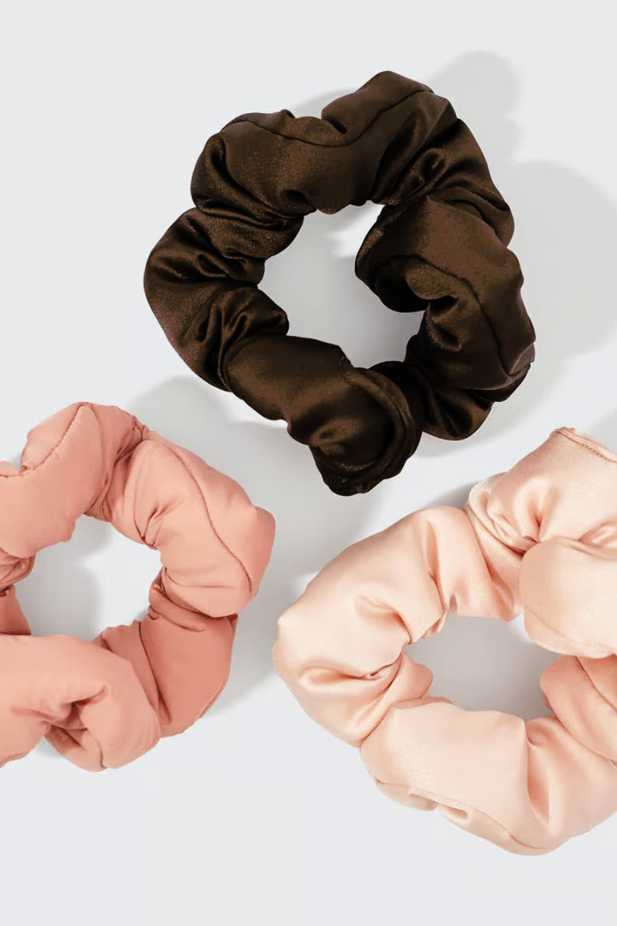 3 scrunchies laying on white background
