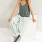 full front view of Romee v neck cami in the color forest, model is sitting 