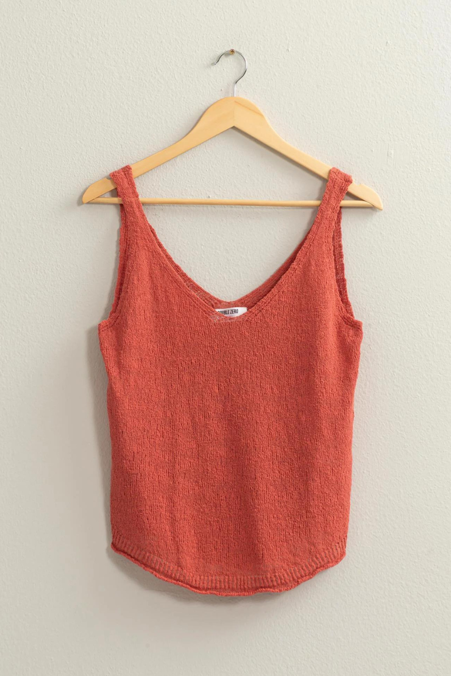 full length shot of brink knit top hanging on hanger