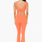 full length back view of venice twist back jumpsuit in the color coral