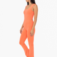 side view of the Venice twist back flare jumpsuit in the color coral 
