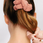 girl with a ponytail with blush satin Scrunchie in her hair 