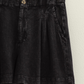 close up of black mineral washed linen shorts 