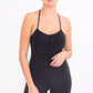 close up front view of Justina spaghetti strap romper in the color black 