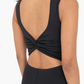 close up detail view of the twist back an cut out on the venice jumpsuit in color black 