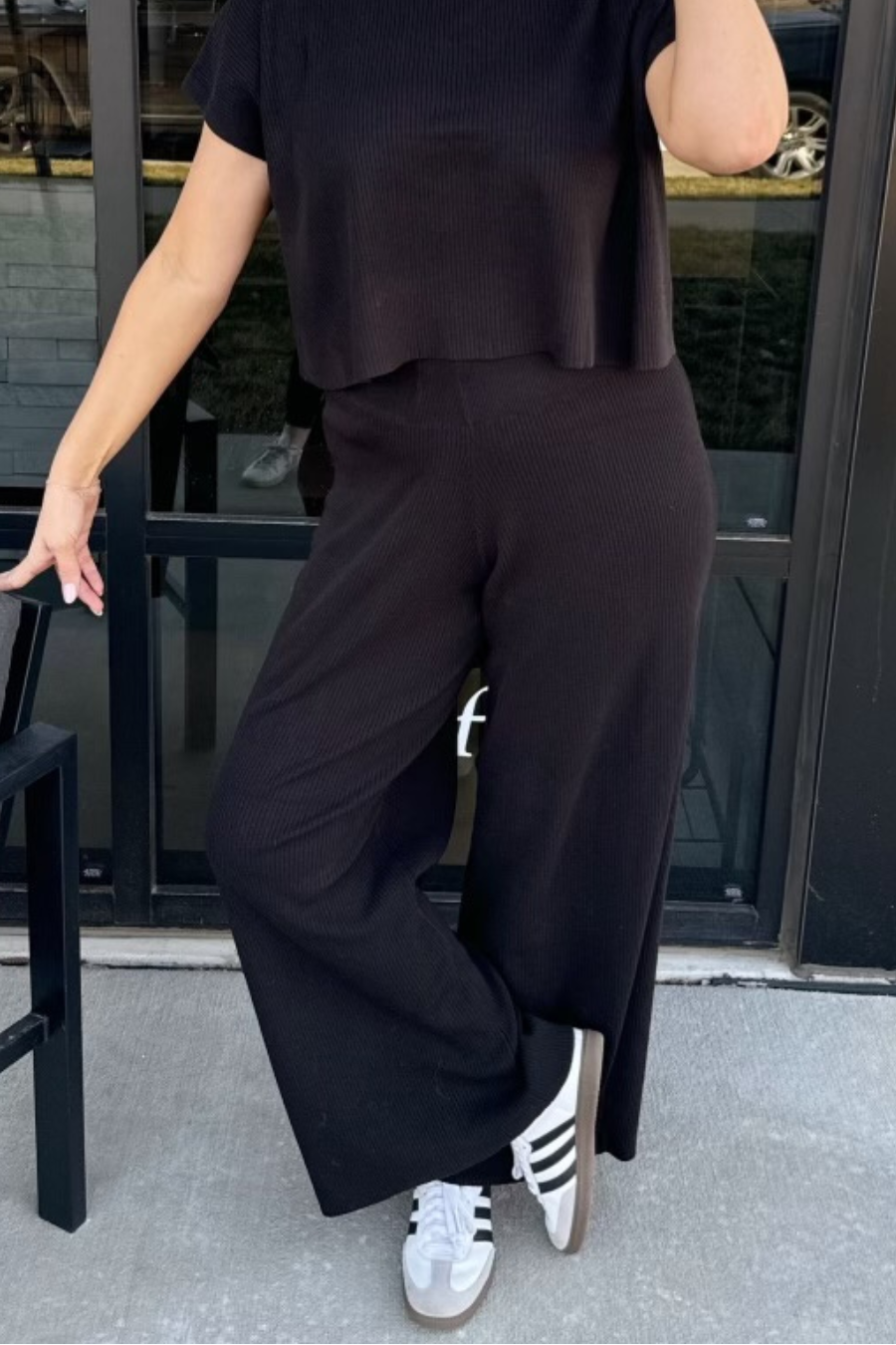 girl wearing knit wide leg pants with tennis shoes 