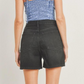close up back shot of girl wearing blue flower top and black denim shorts. 