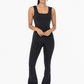 front full length view of the Venice twist back flare jumpsuit  in the color black 